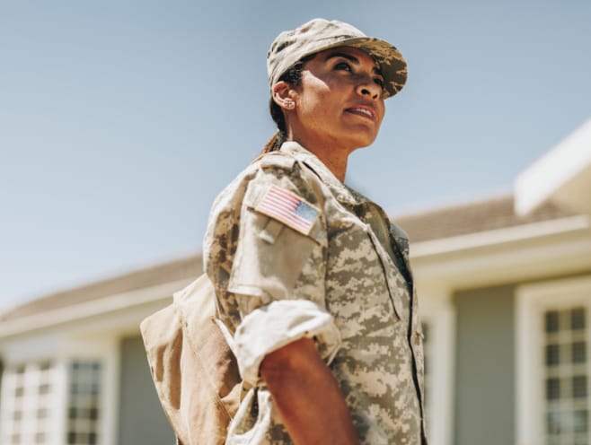 A military service member looks out into the distance.